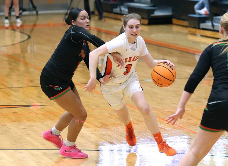 DeKalb's Olivia Schermerhorn drives around Plainfield East's Valeria Ramos Thursday, Feb. 12, 2026, during their game at DeKalb High School.