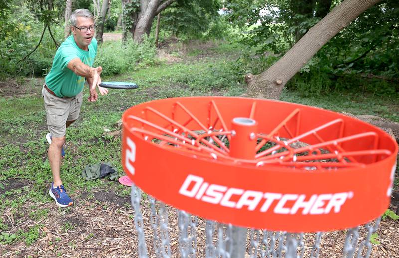 Brian Wallace, with the Kishwaukee Valley Wanderers, gets his birdie Thursday, Sept. 2, 2022, at the new River Run Disc Golf Course in David Carroll Memorial Park in Genoa.