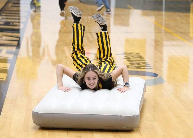 Putnam County High School senior Maddy Wasilewski belly flops on a matress during the football Homecoming Pep Rally on Friday, Sept. 27, 2024 at Putnam County High School in Granville.
