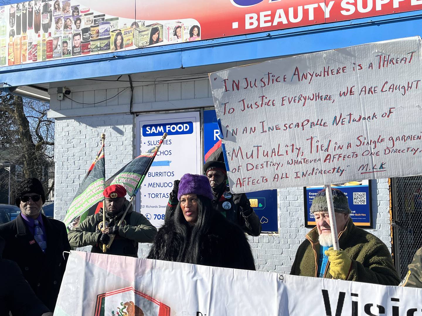 Trista Graves Brown (center), founder of SpeakUp, speaks at a rally held on Saturday, Jan. 4, 2025, outside Sam Food Mart, 121 Richards St., Joliet.