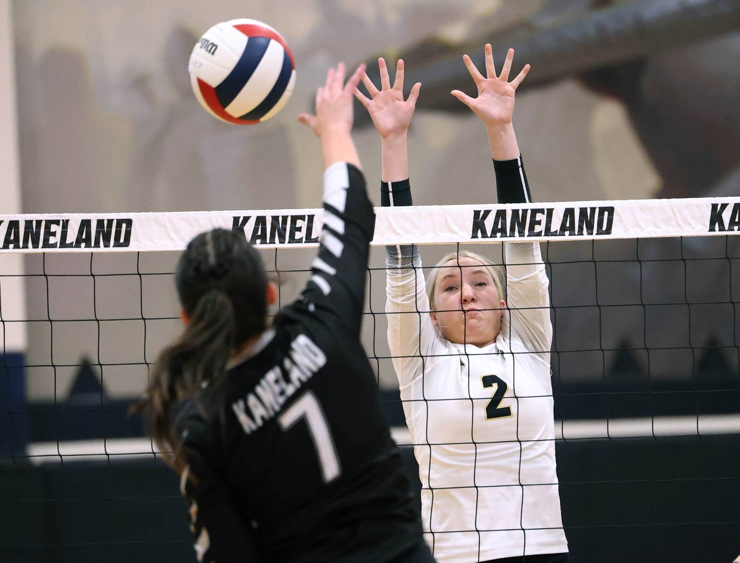 Sycamore's Madilyn Patton tries to block the spike of Kaneland's Brielle Gadomski during their match Tuesday, Sept. 30, 2025, at Kaneland High School in Maple Park.