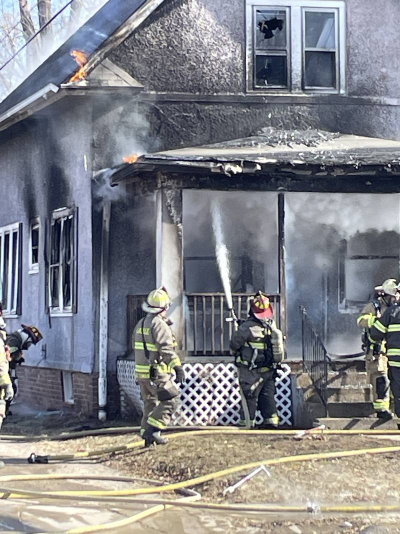 Emergency personnel from La Salle, Peru, Oglesby and Utica fire departments work together Friday, Jan. 23, 2026, at the scene of a fully involved structure fire on Bucklin Street in La Salle.