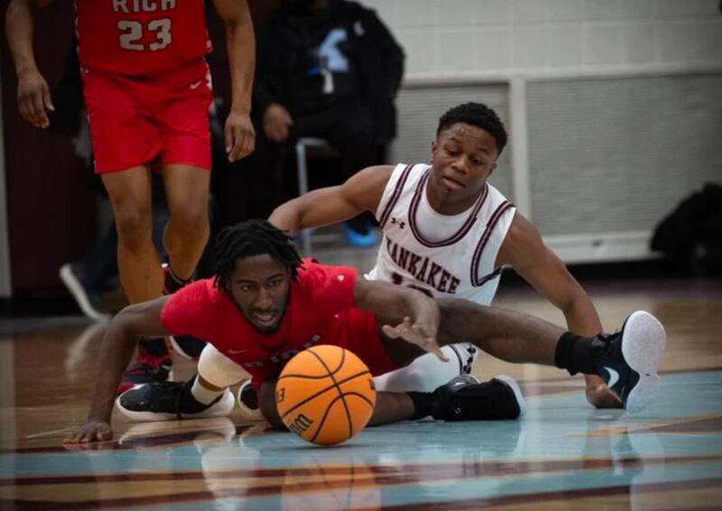Kankakee's Myair Thompson, back, and Rich Township's Ikee Brooks look to get a handle on a loose ball during Tuesday's game in Kankakee.