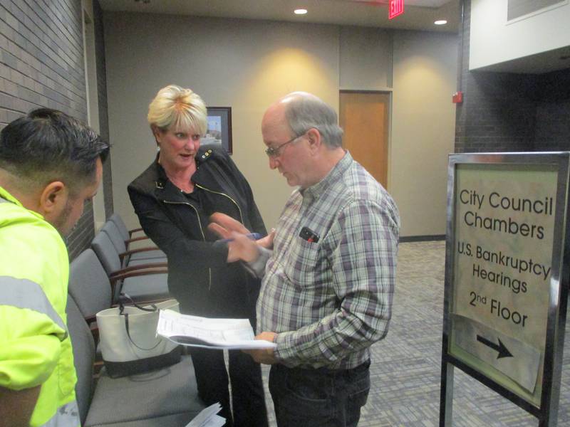 Picardy resident Mary Simeone talks with David Riendeau, an engineer for the Prairie Landing project, about the plans for the housing development after a meeting of the Joliet City Council on Monday. April 14, 2025