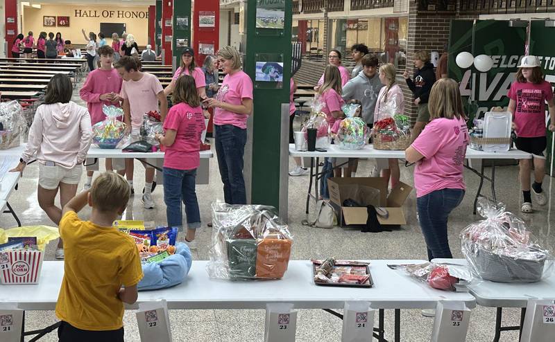 Guests enter raffle tickets to win prizes during the "Cavs 4 A Cause" pink night game on Tuesday, Sept. 26, 2023 outside Sellett Gymnasium between L-P and St. Bede.