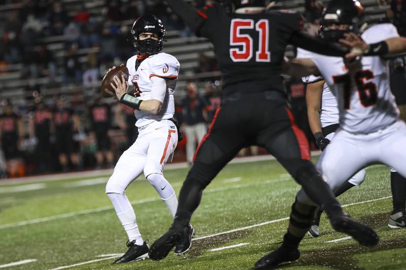Lincoln-Way West's Evan Wydajewski drops back looking for a pass on Friday, March 26, 2021, at Lincoln-Way Central High School in New Lenox, Ill.