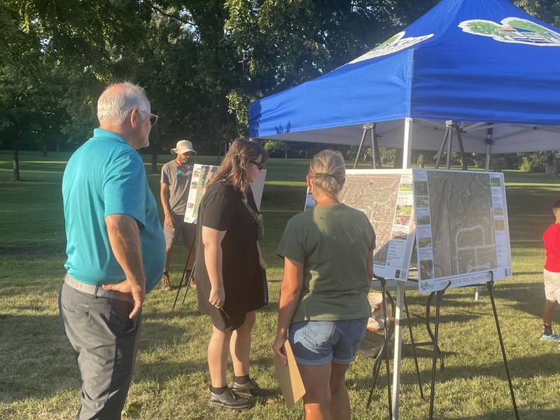 Attendees approach project leaders with feedback Wednesday, Aug. 13, 2025, during an open house at Prairie Park in DeKalb.