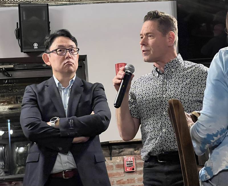 Andy Jeon, an emerging technologies researcher and assistant professor of marketing at NIU, listens as NIU professor of media studies and presidential research David Gunkel responds to a question from the audience at the Oct. 4, 2023 NIU STEM cafe event at Fatty's Pub and Grille in DeKalb.