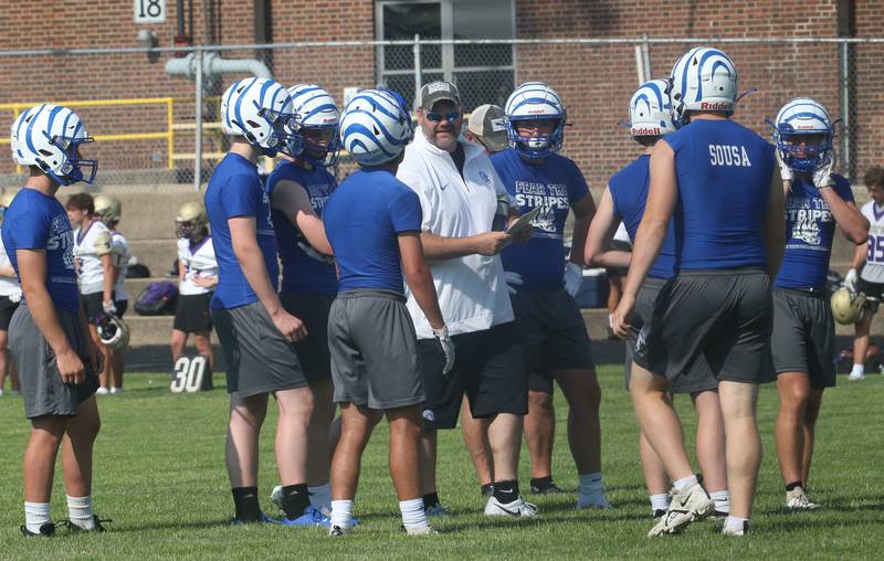 Princeton head football coach Ryan Pearson huddles his team between plays during the 7-on-7 meet on Saturday, July 15, 2023 at Princeton High School.