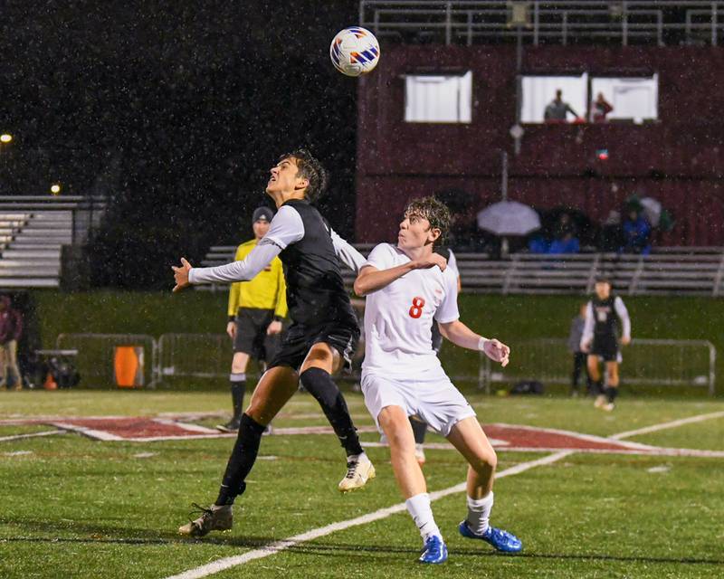 Benet Academy's Mathew Donaghey (8) and Prairie Ridge's Logan Braun, left, tries to head the ball during the class 2A super sectional soccer match on Tuesday Nov. 5, 2024, held at Wheaton Academy in West Chicago.