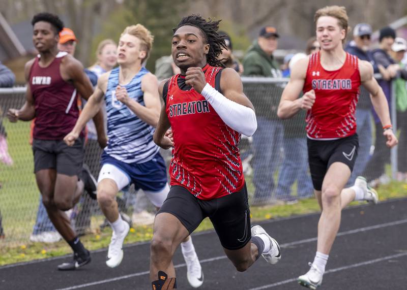 Isaiah Brown of Streator High School leads the pack of runners to the finish line during the boys 200 meter race of the Rollie Morris Invite on April 19, 2025 at Hall High School.
