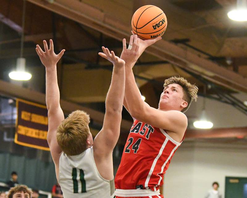 Glenbard East's Sam Walton (24) makes a shot while being defended by Glenbard West's Chase Cavan (11)  on Wednesday Nov. 26, 2025, during the District 87 Thanksgiving Invitational held at Glenbard West High School.