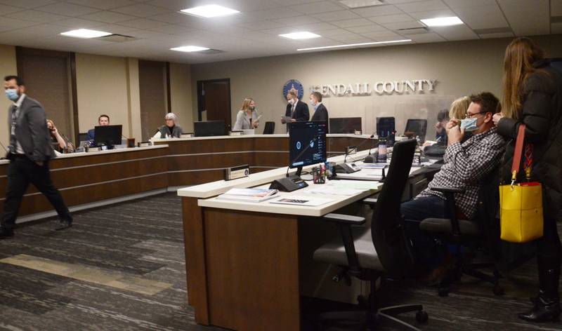 Kendall County officials prepare for a meeting in the county board meeting room on Tuesday, March 2, 2021. (Lucas Robinson - lrobinson@shawmedia.com)