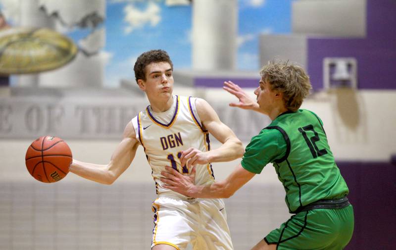 Downers Grove North’s Jack Crowley looks to pass the ball around York’s Brendan Molis during a game at Downers Grove North on Friday, Jan. 19, 2024.