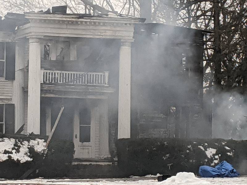 Firefighters remain on the scene at 407 Main St. near downtown Oswego. Built in the 1900s, the house is called The Pillars because of the 36 pillars located in and around the house.
