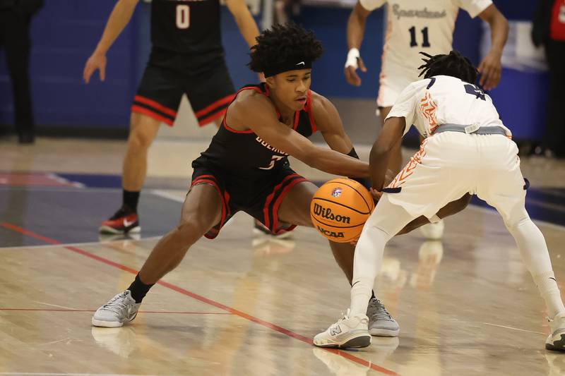 Bolingbrook's TJ Williams steals the ball against Romeoville on Tuesday, Dec. 2, 2025 in Romeoville.