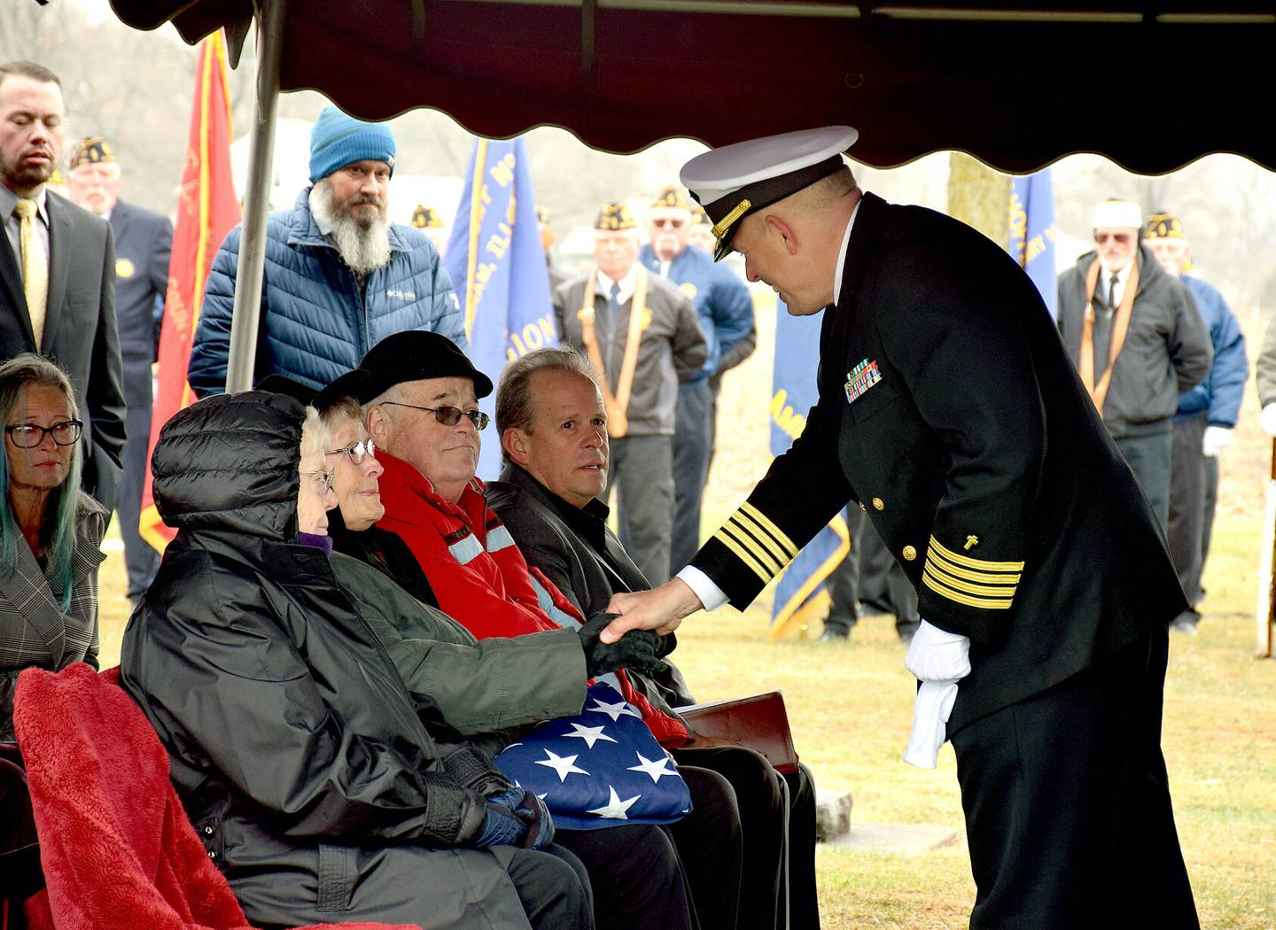 U.S. Navy Chaplain Andy Richards, right, shakes the hand of Keith Tipsword’s sister, Dalyne Sapp, after giving her a folded American flag. To the left of Dalyne is another of Tipsword’s relatives, Bonnie Kemme. To Dalyne’s right are Greg Sapp and Brett Sapp.
Effingham Daily News