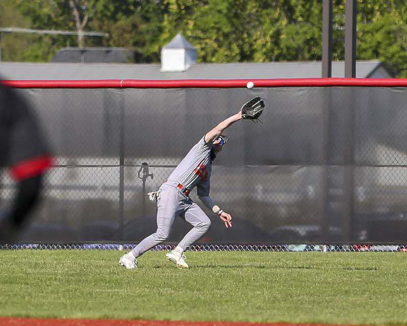 Oswego's Jacob Fehrmann (17) makes a catch in the outfield during baseball game between Oswego at Yorkville. Thursday, May 8, 2025 in Yorkville.