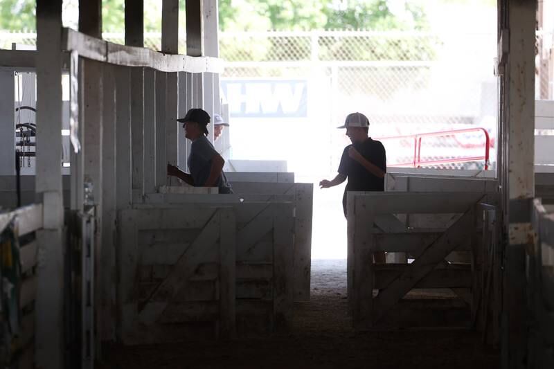 Kids play a game of tag inside one of the livestock holds areas at the Grundy County 4-H Fair on Sunday, July 30 in Morris.