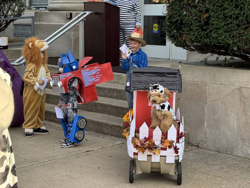 Maverick, from Marseilles, dressed as a farmer, complete with a wagon for his barn and his dog dressed as a cow on Thursday, Oct. 30, 2025.