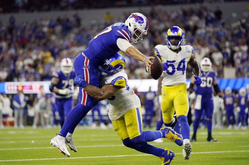 Buffalo Bills quarterback Josh Allen (17) lunges into the end zone for a touchdown over Los Angeles Rams linebacker Bobby Wagner during the second half of an NFL football game Thursday, Sept. 8, 2022, in Inglewood, Calif. (AP Photo/Ashley Landis)