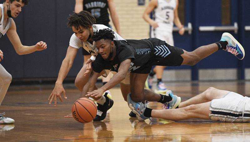 John Starks/jstarks@dailyherald.com
Willowbrook’s Terrell Walker dives for the ball with Addison Trail’s Nathan Johnson in a boys basketball game in Addison on Tuesday, January 18, 2022.