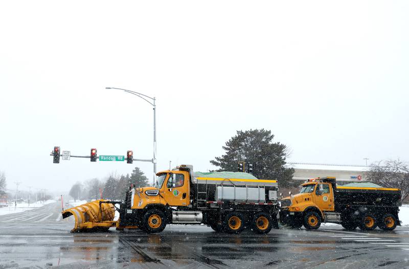 Snow plow trucks travel south on Randall Road in Batavia during a snowstorm on Tuesday, Jan. 9, 2024.