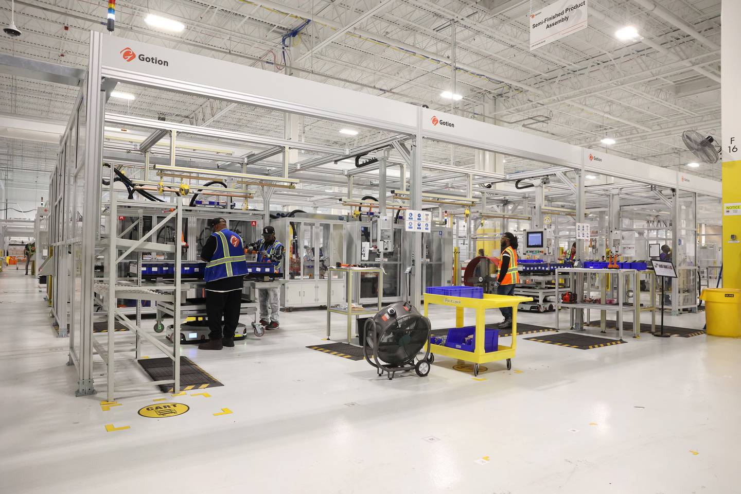 Workers complete a step in the assembly line at Gotion Illinois in Manteno on Oct. 1, 2025. The battery manufacturing plant has plans to expand its workforce to 450 jobs by the end of 2025, with the goal of reaching 1,400 jobs in 2026.