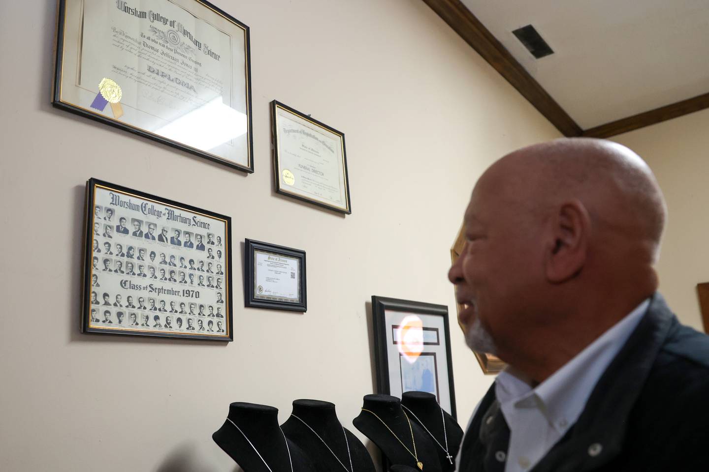 Jeff Jones looks back at his diploma and 1970 graduating class from obtain his mortician’s license from Worsham College of Mortuary Science, hanging on his office wall at Jones Funeral Home in Kankakee on Feb. 18, 2026. Jones, who took over after his father Thomas Jefferson Jones, Jr., has stewarded the the family business into its 70th year.