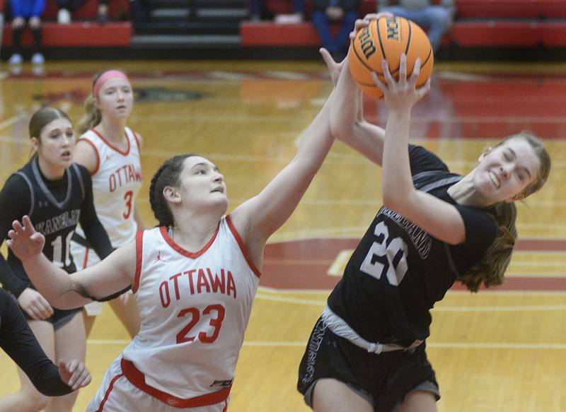 Ottawa’s Mary Stisser (23) and Kaneland’s Samantha Kerry (20) fight for a rebound during the fourth quarter of a girls/boys Interstate 8 Conference twin bill Friday, Dec. 6, 2024, at Kingman Gym in Ottawa.
