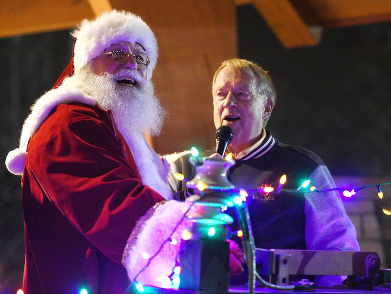 Santa Claus, left, and Batavia Mayor Jeff Schielke flip the power switch during the city’s annual tree lighting in Batavia Sunday, Nov. 27, 2022.