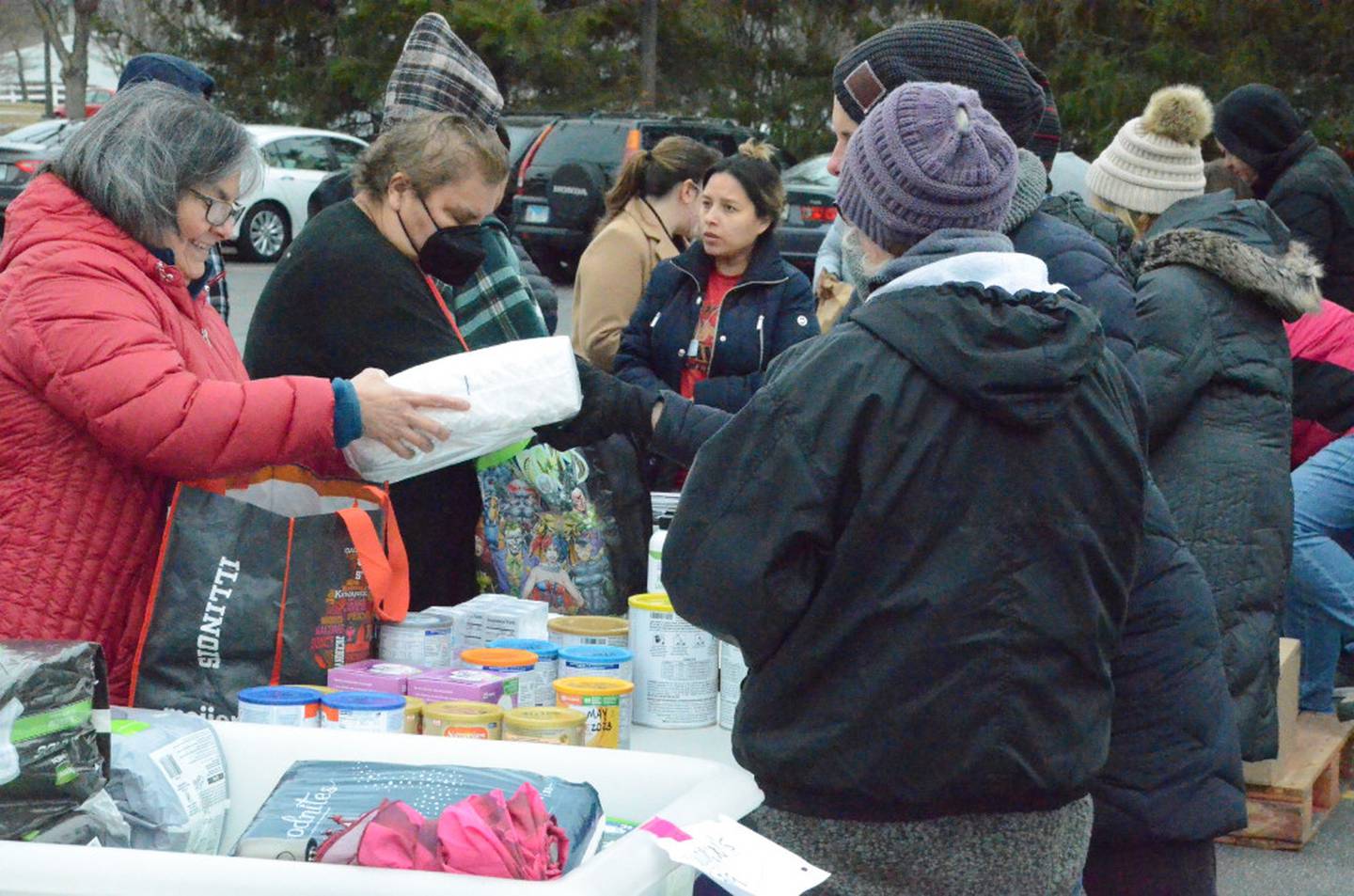 Guests claim free groceries and household products at a March mobile food pantry distribution by Aurora Area Interfaith Food Pantry at Aurora Public Library Eola branch. The next mobile pantry distribution is Saturday, Aug. 5 at the Montgomery Police Department.