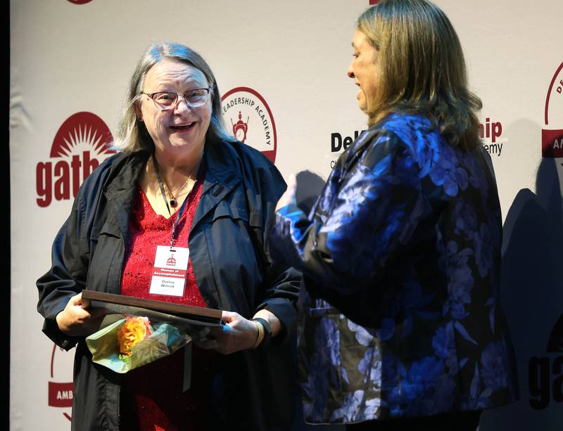 Donna Willrett (left) smiles as she talks to her presenter Dawn Woxell after receiving her certificate for being a Woman of Accomplishment Honoree Thursday, Oct. 16, 2025, during the 35th annual Athena and Women of Accomplishment Award Reception at the Egyptian Theatre in DeKalb.