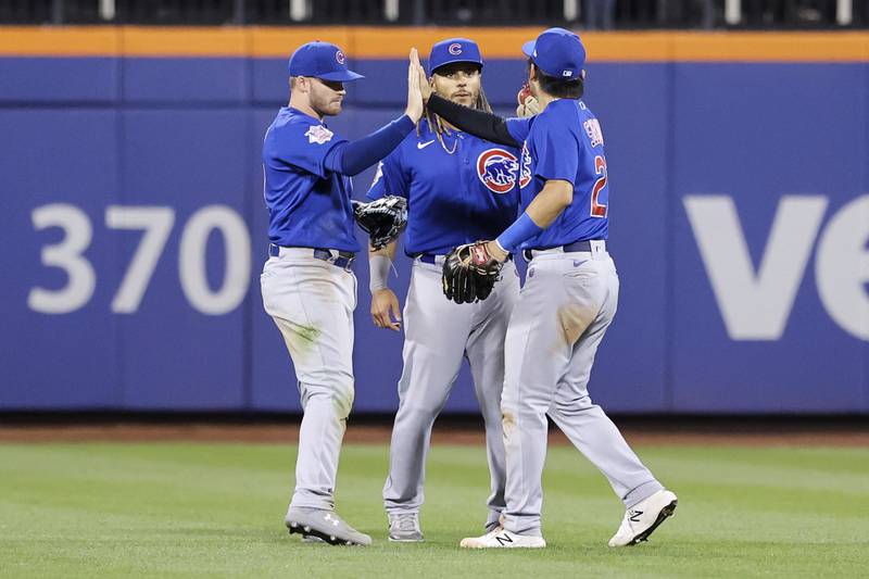 Chicago Cubs left fielder Ian Happ, center fielder Michael Hermosillo, and right fielder Seiya Suzuki celebrate after defeating the New York Mets in baseball game, Tuesday, Sept. 13, 2022, in New York. (AP Photo/Jessie Alcheh)