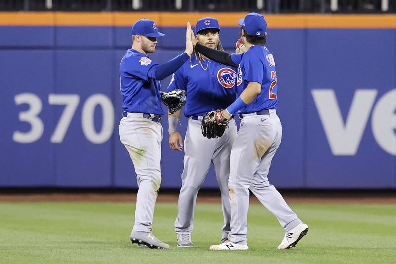 Chicago Cubs left fielder Ian Happ, center fielder Michael Hermosillo, and right fielder Seiya Suzuki celebrate after defeating the New York Mets in baseball game, Tuesday, Sept. 13, 2022, in New York. (AP Photo/Jessie Alcheh)