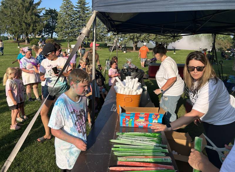 Woods was the sponsor for the Oregon Park District's Concert in the Park on Tuesday, July 22, 2025 at Oregon Park West. They handed out flavored ice sticks which were much appreciated as temperatures climbed to the mid 80s.
