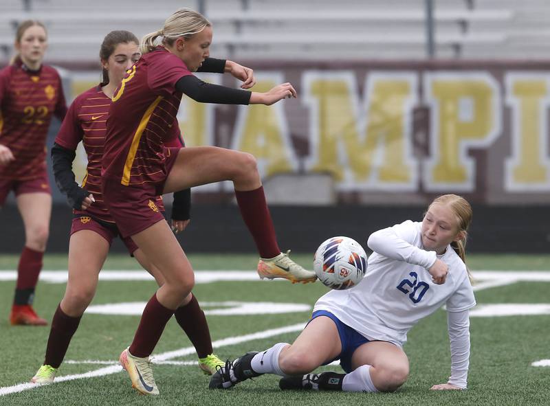 Richmond-Burton's Sydney Frericks tries to kick the ball towards the goal in front of Johnsburg's Kayla Hiller during a Kishwaukee River Conference soccer game on Tuesday, April 1, 2025, at Richmond-Burton High School.