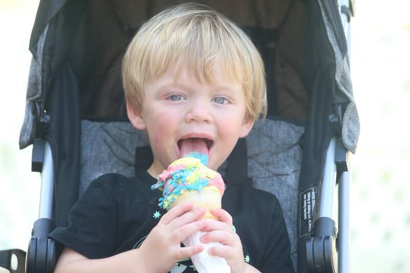 Ky Piecha 2, of La Salle enjoys the first lick of his rainbow sherbet ice cream cone on Thursday, July 27, 2023 at Twisty Freeze in La Salle.