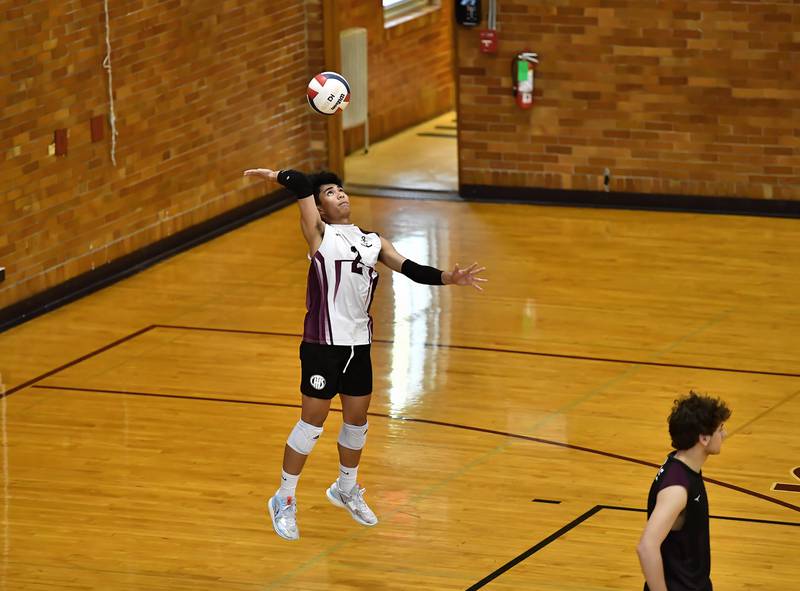 Lockport's Aldrin Rodriguez attempting a jump serve during the regional championship game against Lincoln-Way East on Thursday, May. 25, 2023, at Lockport.