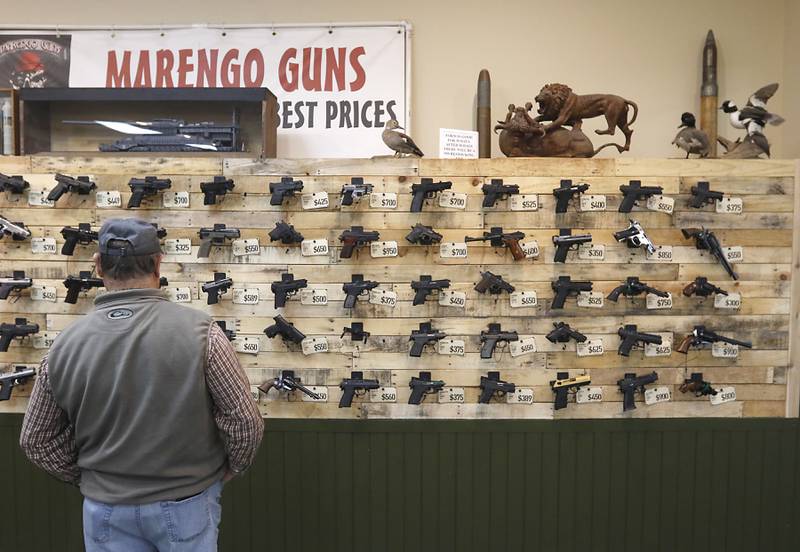 Jeff Norris, of Caledonia, looks at handguns for sale on Wednesday, Jan. 18, 2023, at Marengo Guns. The McHenry County gun shop is among a group of plaintiffs challenging the constitutionality of Illinois’ ban on semiautomatic weapons and large-capacity magazines that took effect last week.