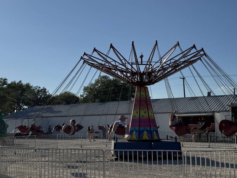 Grundy County Fair-goers go round and round on a giant swing on Thursday, July 3, 2025.