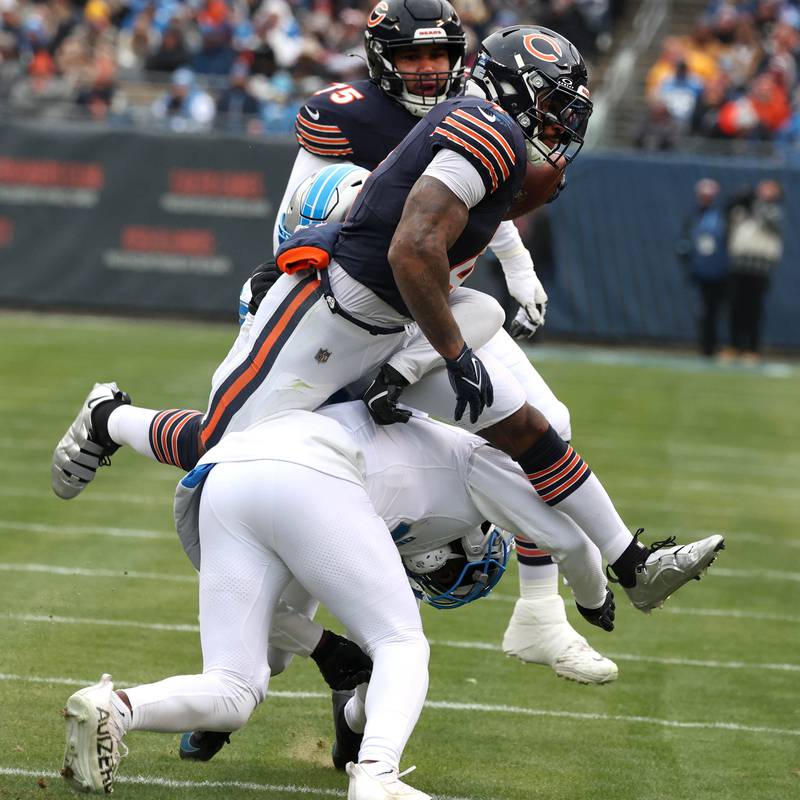Chicago Bears running back D'Andre Swift hurdles Detroit Lions safety Kerby Joseph during their game Sunday, Dec. 22, 2024, at Soldier Field in Chicago.