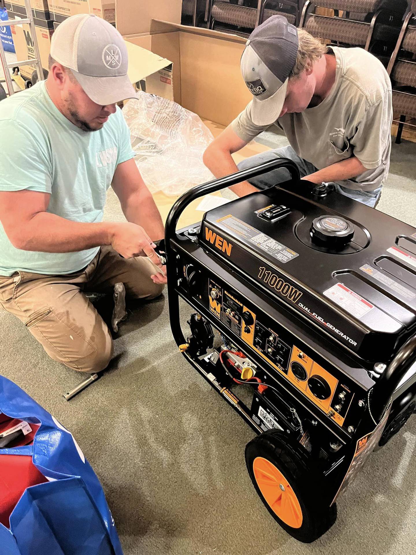 Members of Enon Baptist Church in Marshall, North Carolina get a generator set up for a family to use in wake of Hurricane Helene ravaging the region in September 2024.