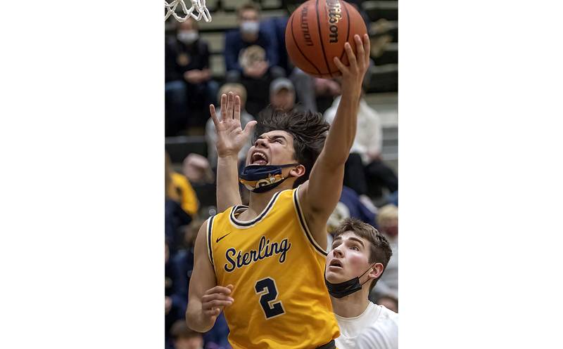 Sterling's JP Schilling gets past a Galesburg defender for a layup during the Golden Warriors' 73-48 Western Big 6 road loss to the Silver Streaks on Tuesday, Jan. 25, 2022 at John Thiel Gymnasium.