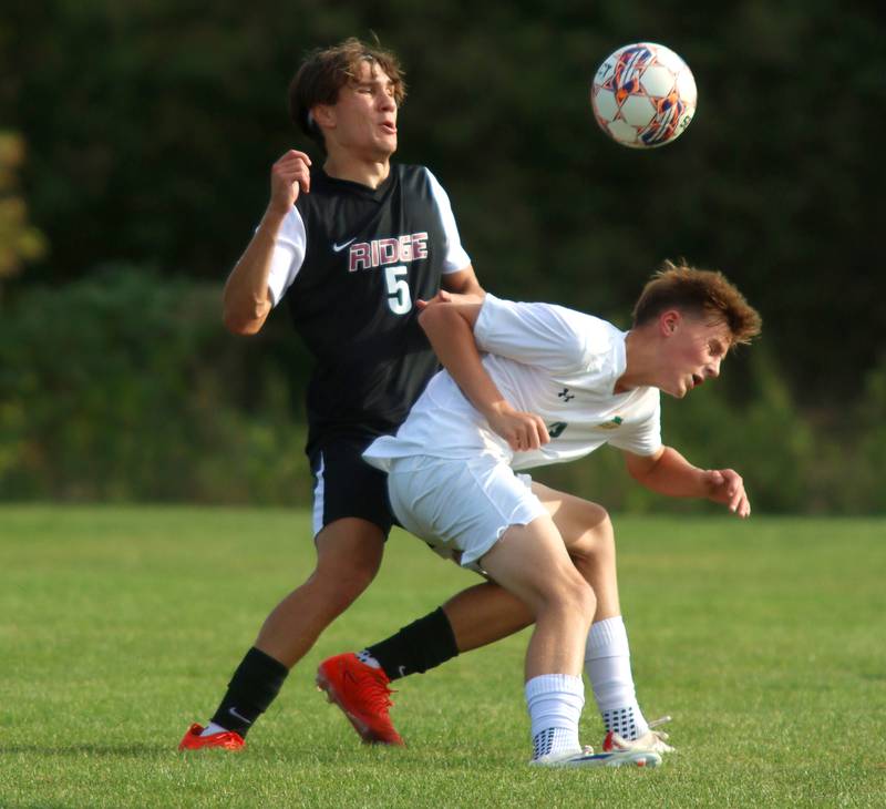 Crystal Lake South’s Ethan Nawracaj battles Prairie Ridge’s Brandon Matei, left, in varsity soccer on Thursday, Sept. 19, 2024, at Prairie Ridge High School in Crystal Lake.