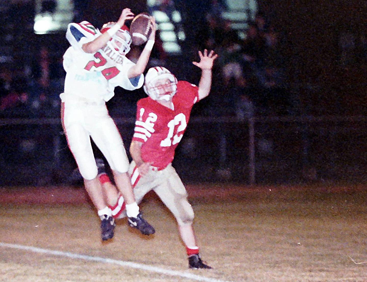 La Salle-Peru's Paul Williams makes a leaping catch in front of Ottawa's Mike Hollenbeck on Friday, Oct. 23, 1992 at King Field in Ottawa.