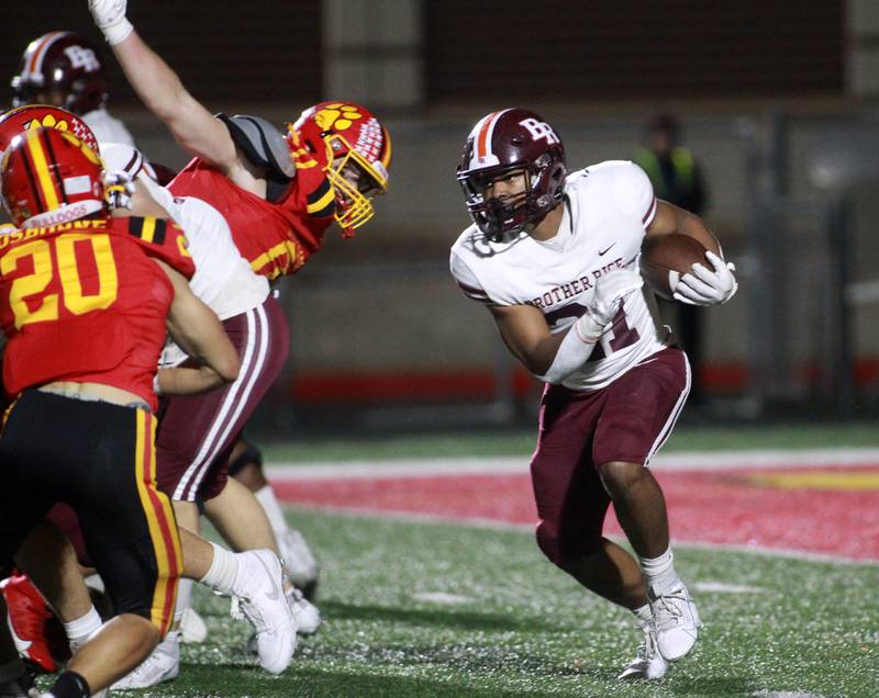 Brother Rice’s Randall Nauden carries the ball during a Class 7A round 1 playoff game in Batavia on Friday, Oct. 27, 2023.