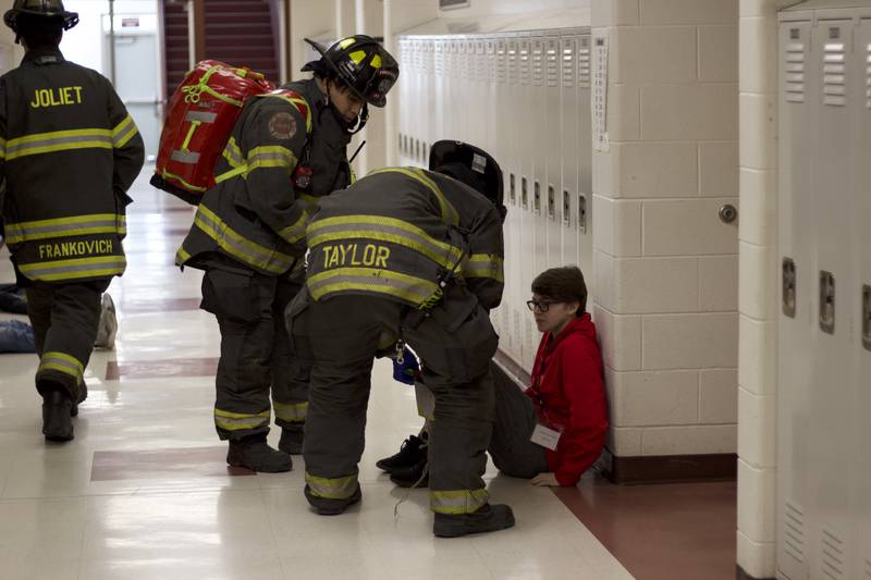 Firefighters inside Joliet West High School on Tuesday, March 25, 2025, for a staged emergency drill simulating the aftermath of a gas explosion.