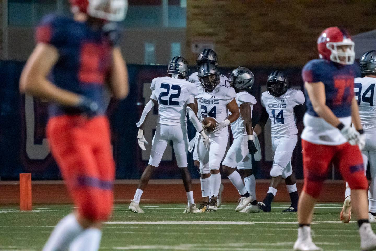 Oswego East's Juny Almeida (24) is met by his team after scoring on a fumble recovery against West Aurora during a high school football game at West Aurora High School in Aurora on Friday, Sep 24, 2021.