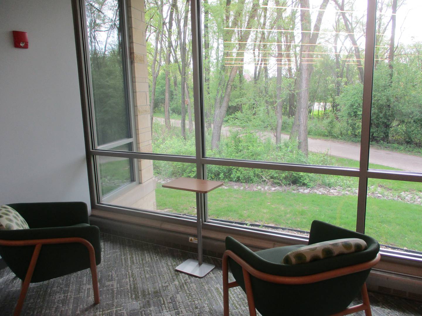 Seating at the Joliet Public Library Black Road Branch provides a view of the Forest Preserve District of Will County Rock Run Preserve. April 24, 2026